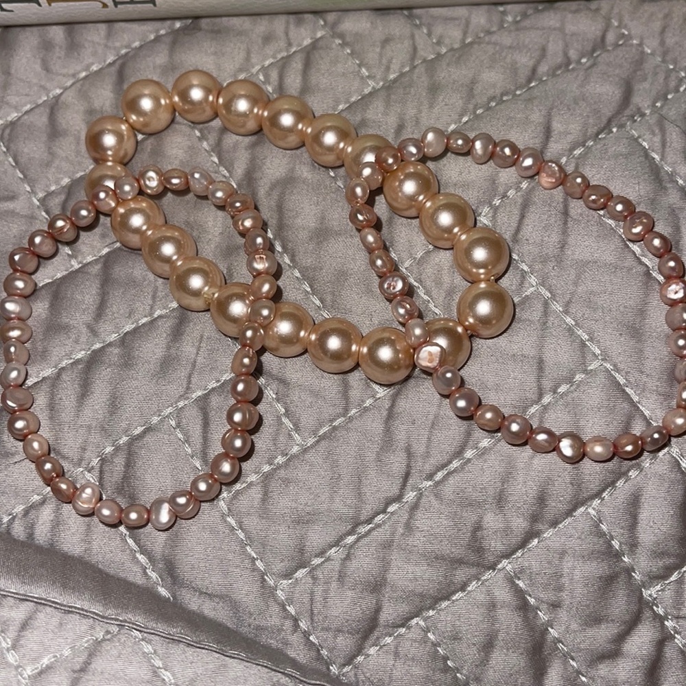 Pink/ Rose assortment of pearl bracelets.